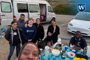 Westcliff University Student Leadership Team preparing dinner while camping