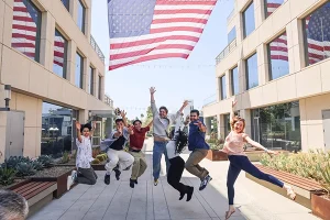 Westcliff University, Irvine, CA. Group of students on campus jumping