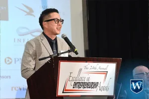 Dr. Lee speaking at podium at OCBJ Entrepreneurship awards