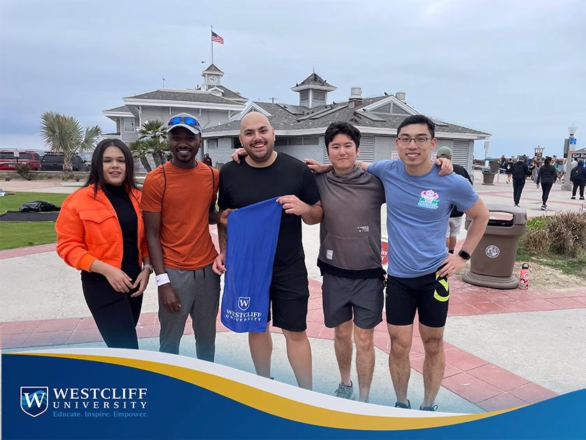 Westcliff University Cross Country Head Coach Abdurrahman Muhammad on track field, marking the program's 2025 return; MBA alumnus and student mentor leading athletic and academic excellence.